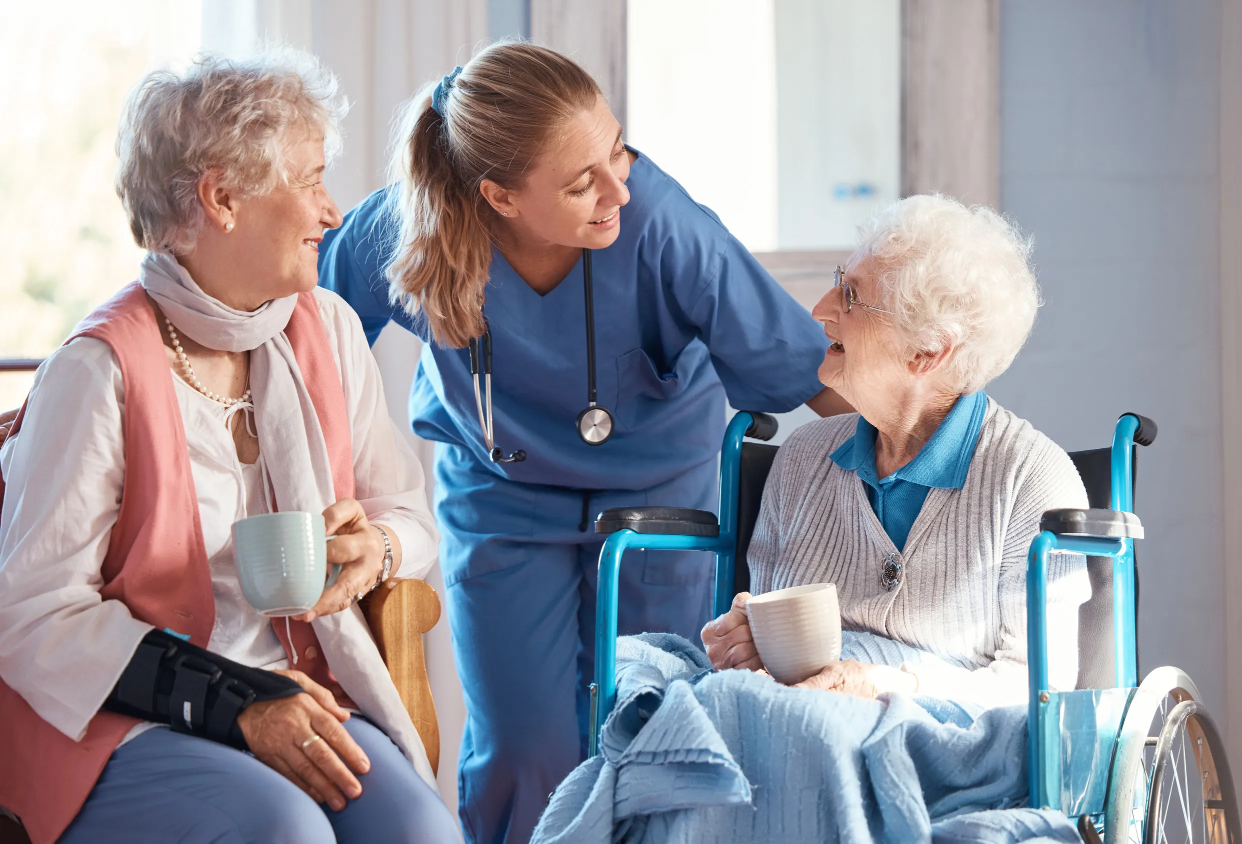 Medical, conversation and elderly woman in wheelchair consulting a doctor at retirement facility